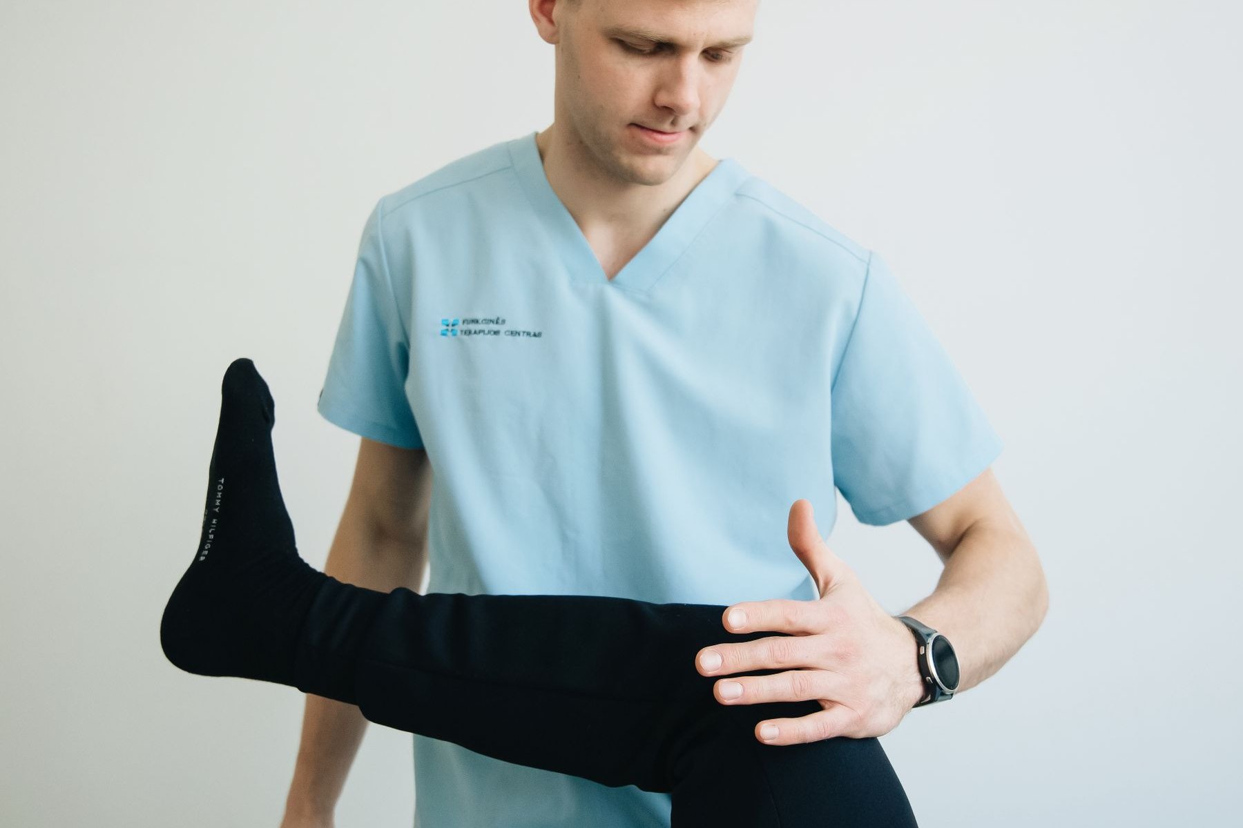 Clinician examining a knee through flexion and rotation to test for a meniscus tear