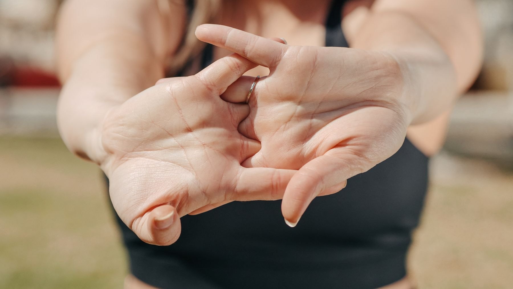 Close-up of hands working stiff fingers and thumb joints, typical of hand and thumb osteoarthritis