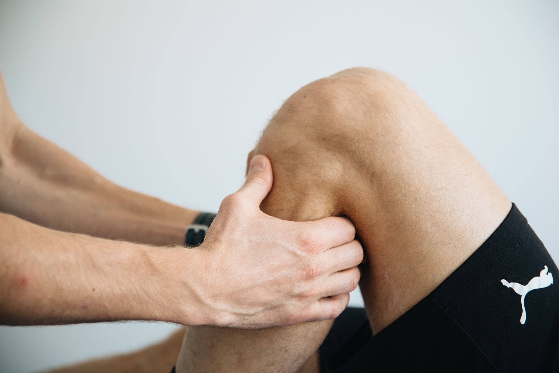 Physical therapist treating a patient's knee in the clinic