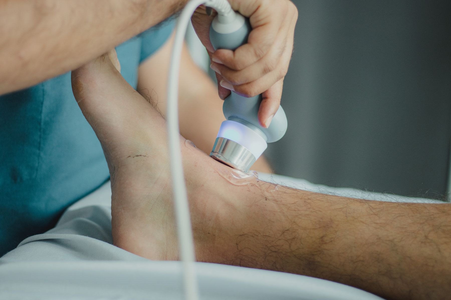 Physical therapist treating a patient's lower leg in the clinic