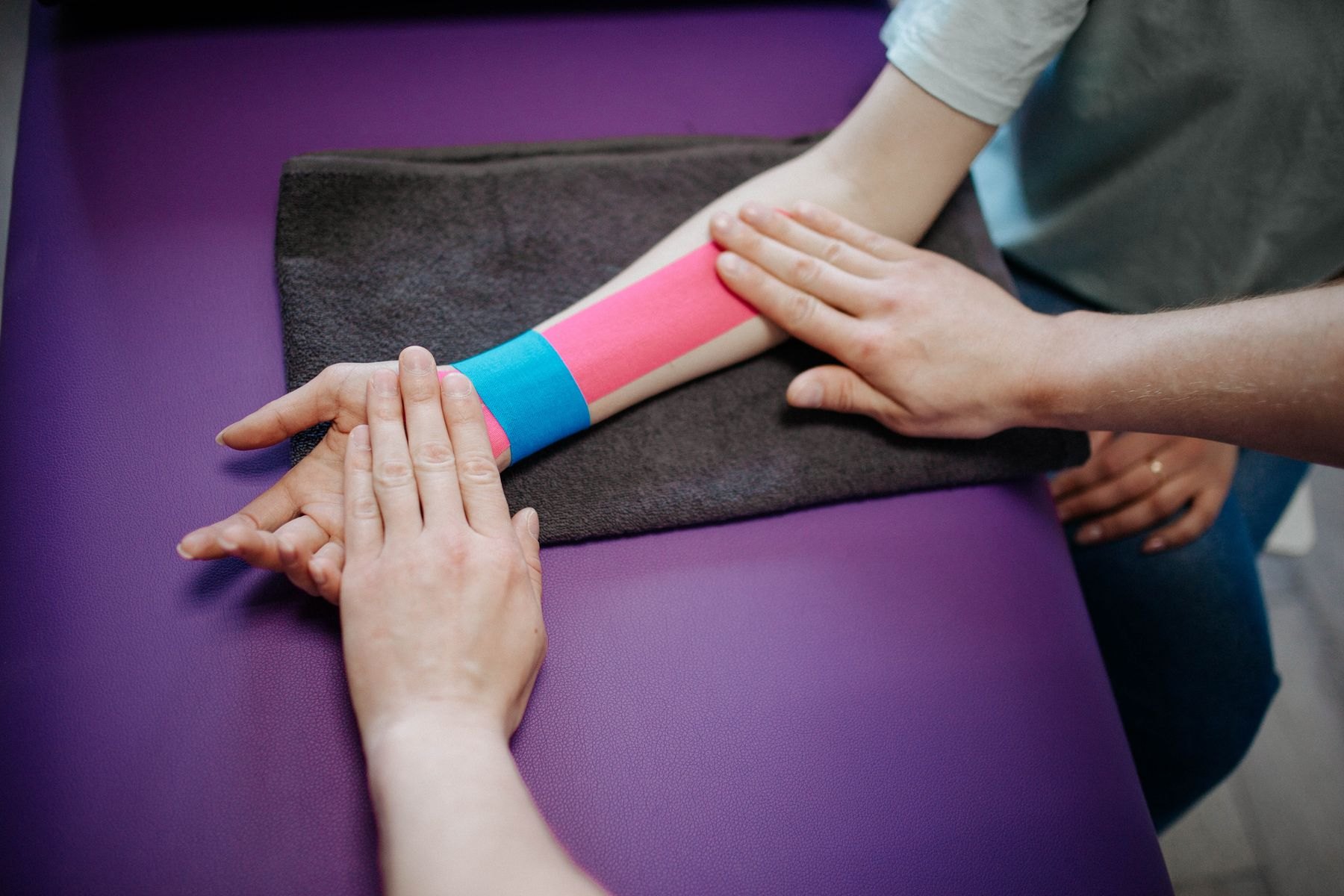 Therapist performing hands-on treatment of a patient's hand and wrist for thumb base arthritis